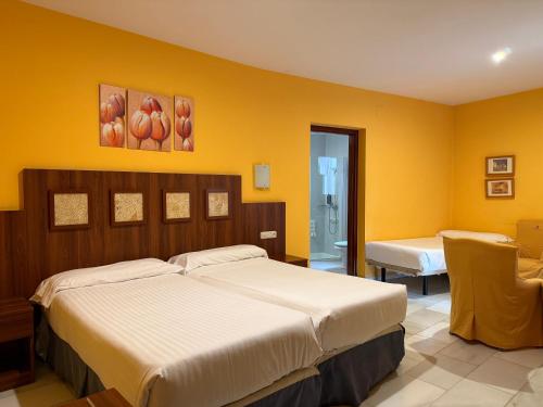 Postel nebo postele na pokoji v ubytování Hotel Nuevo Palas
