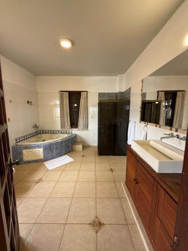 a large bathroom with a tub and a sink at Hotel Casablanca Boutique Ciudad del Este By Swiss Bonmont Hotels in Ciudad del Este