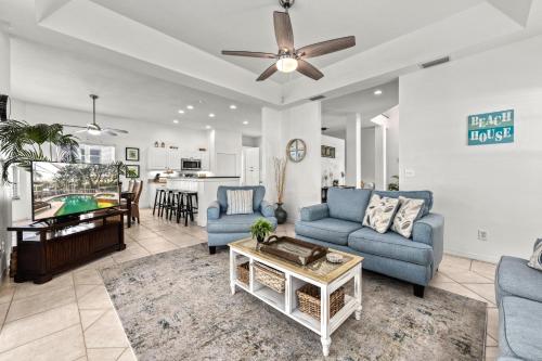 a living room with two blue couches and a table at Villa Champagne - 5322 in Siesta Key