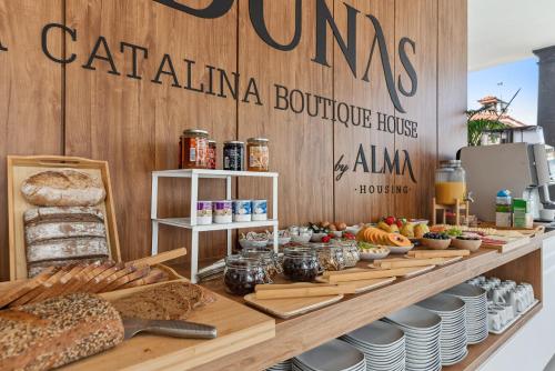 a bakery with bread and other food on a counter at Las Dunas de Santa Catalina Boutique House in Las Palmas de Gran Canaria