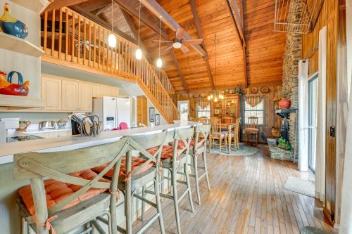 a kitchen with a counter and a bar with stools at Mtn-View Home with Deck, Fire Pit and BBQ in Almond in Almond