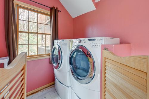 a washer and dryer in a room with pink walls at Mtn-View Home with Deck, Fire Pit and BBQ in Almond in Almond