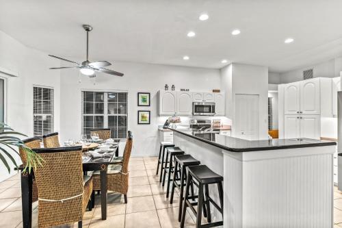 a kitchen and dining room with a table and chairs at Villa Champagne - 5322 in Siesta Key