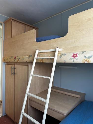 a bunk bed with a ladder in a room at Golden Sands Park Ingoldmells in Ingoldmells