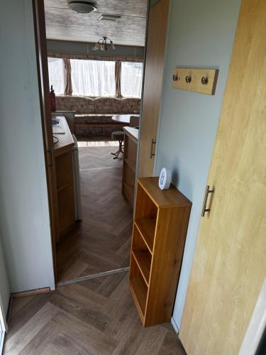 a room with a hallway with a door and a table at Golden Sands Park Ingoldmells in Ingoldmells