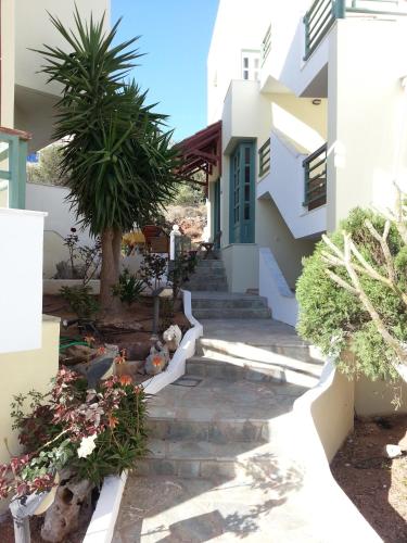 a house with a staircase leading to the front yard at Elia Studios in Palekastron