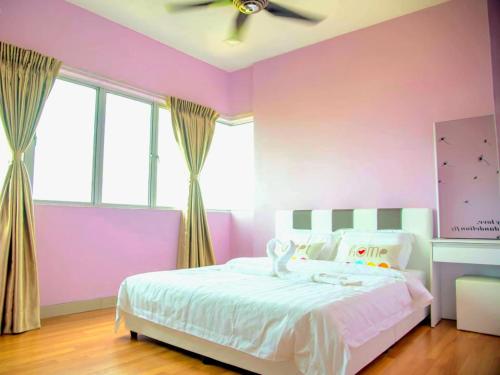 a pink bedroom with a bed with a ceiling fan at 7楼紫钞屋 Comfy Purple House with Beautiful Seaview and Paddy Field View in Sekincan