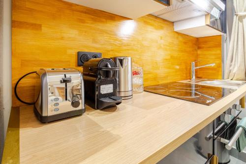 a kitchen counter top with a toaster and a toaster and a toaster at Studio Luxe & Confort - Elegance Coeur de Béziers in Béziers