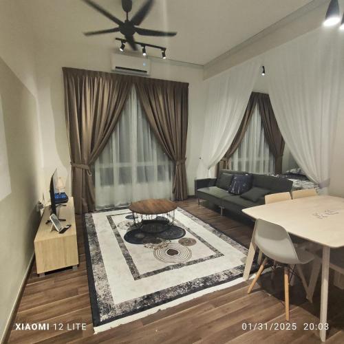 a living room with a couch and a table at AZ Mahkota Valley Suites studio in Kuantan