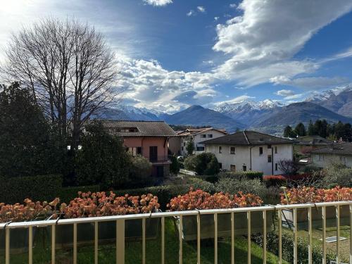 a view of a house with mountains in the background at Casa Rio - Relax on Lake Como with Wi-Fi and Air Conditioning in Colico