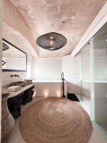 a bathroom with a large round rug on the floor at Bellavista Suites in Monopoli