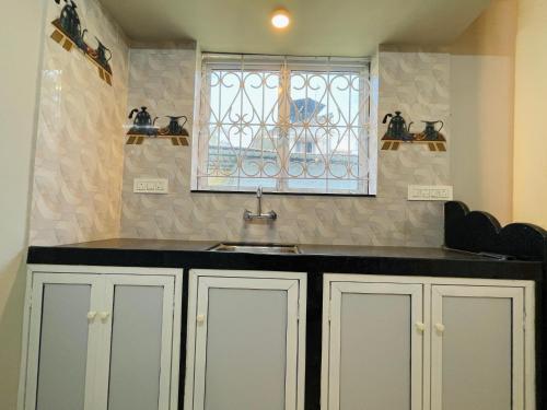 a kitchen with a sink and a window at Blue Horizon 2BHK 5 min Colva Beach in Colva
