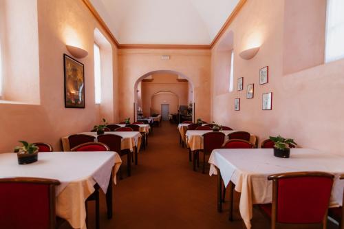 a row of tables in a restaurant with white table cloth at Casa REGINA MONTIS REGALIS in Vicoforte