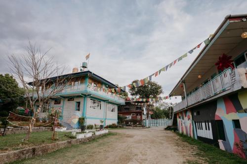 a house with flags on the side of a street at The Hood in Bīr