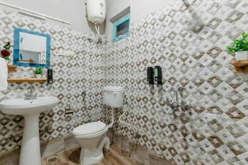 a bathroom with a toilet and a sink at The Hood in Bīr