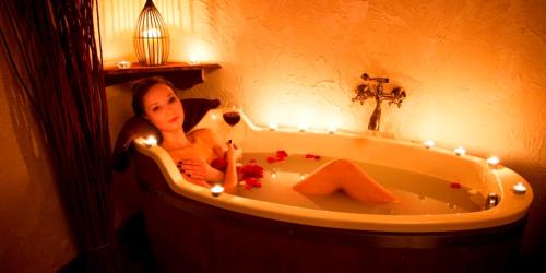 a woman sitting in a bath tub with lights at Olandia in Kwilcz