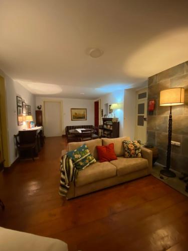 a living room with a couch with pillows on it at Casa da Vinha Grande in Poiares