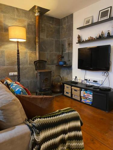 a living room with a couch and a flat screen tv at Casa da Vinha Grande in Poiares