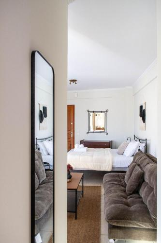 a living room with a bed and a mirror at Rokani Studio II at Kalavrita Center in Kalavrita