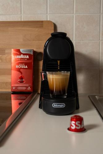 a black coffee maker sitting on a counter with a drink at Rokani Studio II at Kalavrita Center in Kalavrita