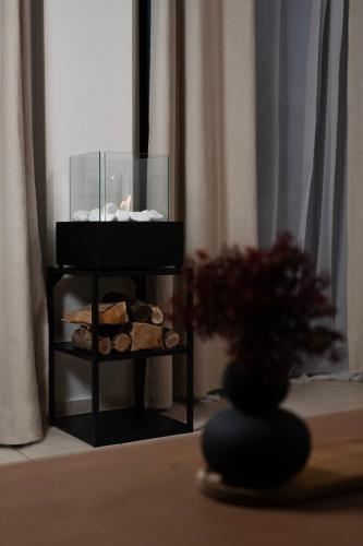 a stand with cookies and a vase with a plant at Rokani Studio II at Kalavrita Center in Kalavrita