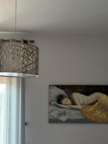 a picture of a woman laying in a hammock on a wall at Hotel Il Giardino degli Aranci in Nola