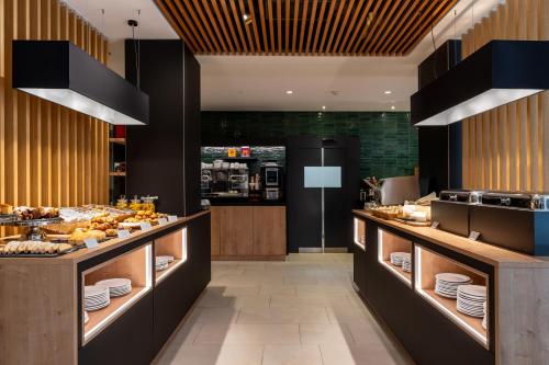 a buffet line in a restaurant with food on display at Elite Hotel & Spa in Mestre