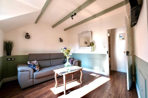 a living room with a couch and a table at Appartement Le Balcon de L'Oust in Malestroit