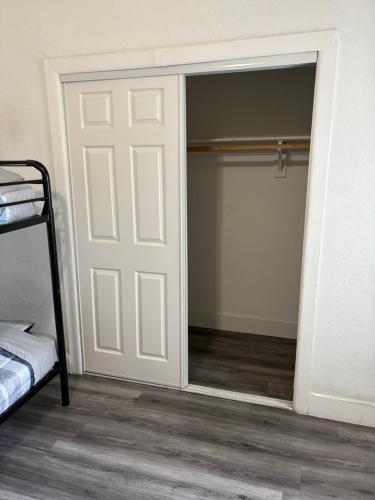 a bedroom with a door leading to a closet at Miami Coliving shared House for professionals in Miami