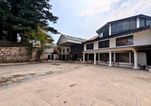 an empty parking lot in front of a building at Grand Heights Hotel in Murree