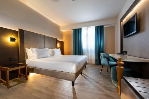 a hotel room with a bed and a desk at Elite Hotel & Spa in Mestre