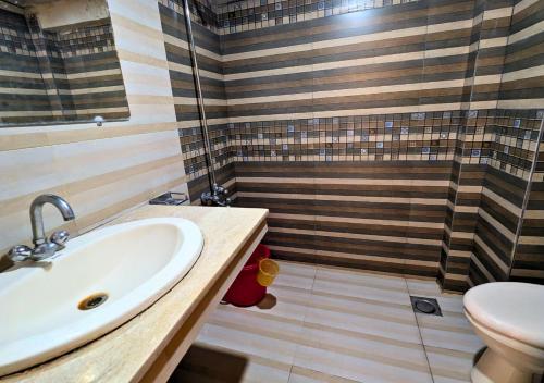 a bathroom with a sink and a shower at Grand Heights Hotel in Murree