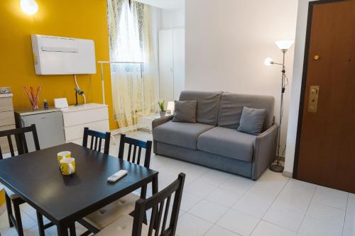 a living room with a table and a couch at Il Girasole in Florence