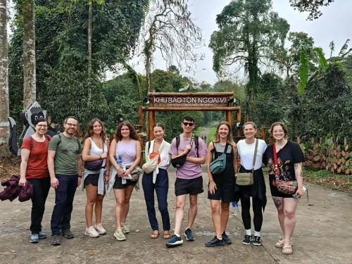 a group of people standing in front of a sign at Tam Coc Moutainside Homestay in Ninh Binh