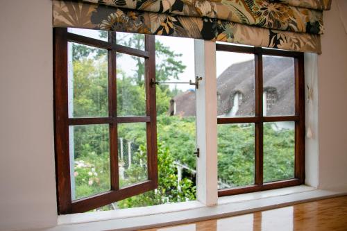an open window with a view of a garden at Rawdons Hotel & Brewery in Nottingham Road