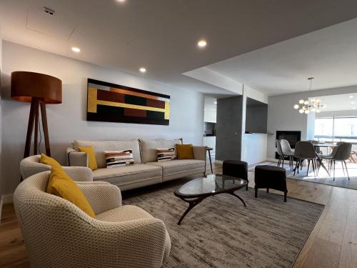 a living room with a couch and a table at FLH Cascais Atrium Luxury Apartment with Sea View and Pool in Cascais