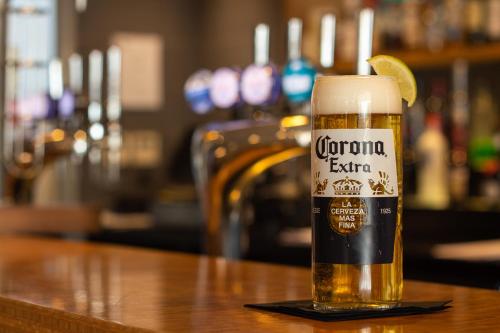 a glass of beer sitting on a table at Novotel London Wembley in London