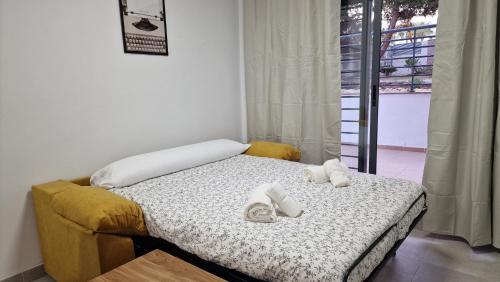 a bedroom with a bed with two slippers on it at Gran terraza Apartamento playa Garrucha in Garrucha