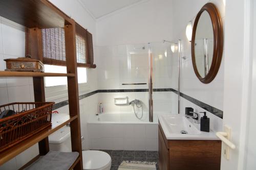 a bathroom with a sink and a toilet and a mirror at Apricot House in Kavála