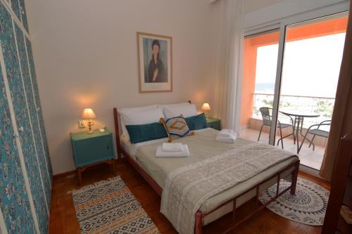 a bedroom with a bed with a view of a balcony at Apricot House in Kavála