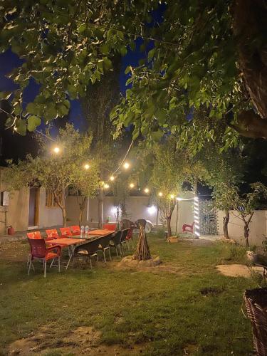 a table and chairs in a yard at night at Biafo Resort Skardu in Skardu