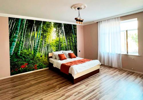 a bedroom with a large mural of a forest at Soft Villa in Gabala