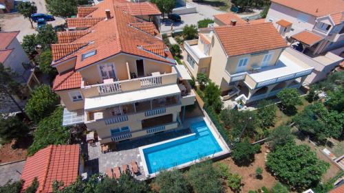 an aerial view of a house with a swimming pool at Pansion Tina in Šilo