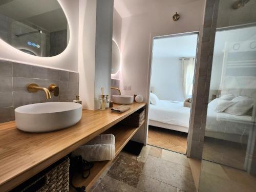 a bathroom with a sink and a mirror at Villa Marine, Jacuzzi, 25' Disneyland in La Celle-sur-Morin