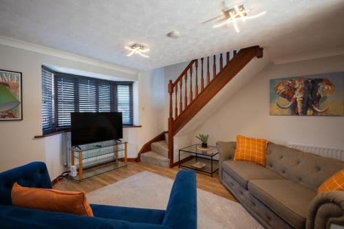 a living room with a couch and a flat screen tv at Eastwood in Colchester