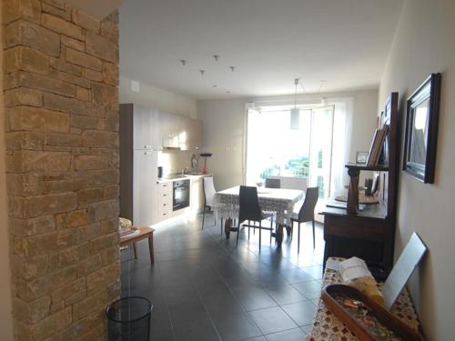 a living room with a kitchen and a dining room at La casa dei nonni in Monforte dʼAlba