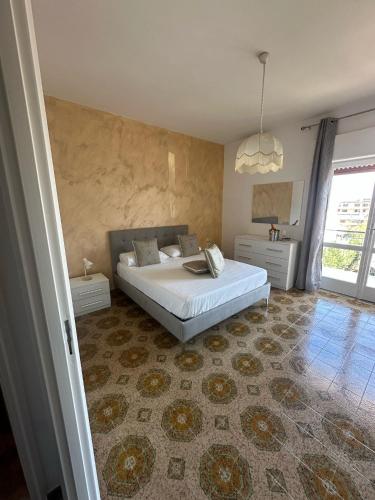 a bedroom with a large white bed in a room at Greta Apartment Tropea in Tropea