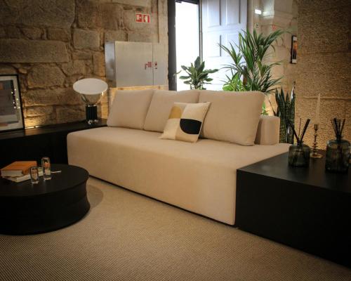 a large white couch in a room with plants at MS Collection Arouca - Mosteiro de Arouca in Arouca