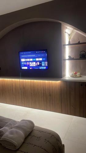 a room with a flat screen tv on a wall at Incanto Luxury Suites 2 in Nafpaktos
