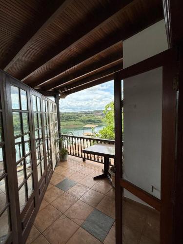 a porch with a bench and a view of the water at Hotel Casablanca Boutique Ciudad del Este By Swiss Bonmont Hotels in Ciudad del Este